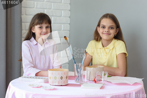 Image of Children sit at the table and prepare for the celebration of Easter