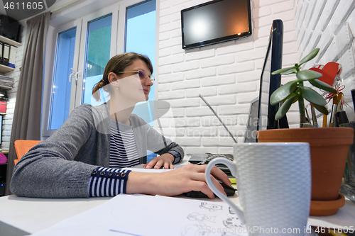 Image of Freelancer girl works at home at her workplace