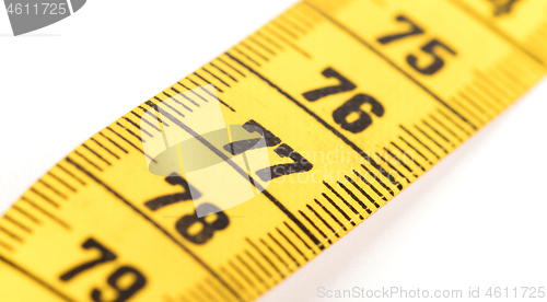 Image of Close-up of a yellow measuring tape isolated on white - 77