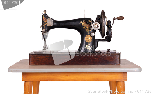 Image of Antique, vintage sewing machine on an old table