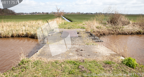 Image of Old concrete and wooden crumbling bridge 