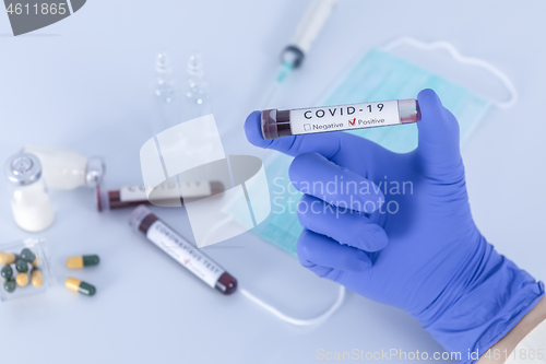 Image of Analyst hand holding COVID 19 Coronavirus test blood