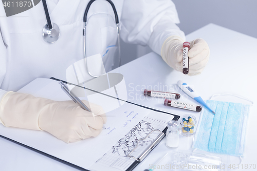 Image of Doctor hands holding COVID 19 Coronavirus test blood making stat