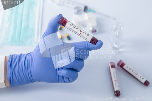 Image of Doctor hand holding COVID 19 Coronavirus test blood