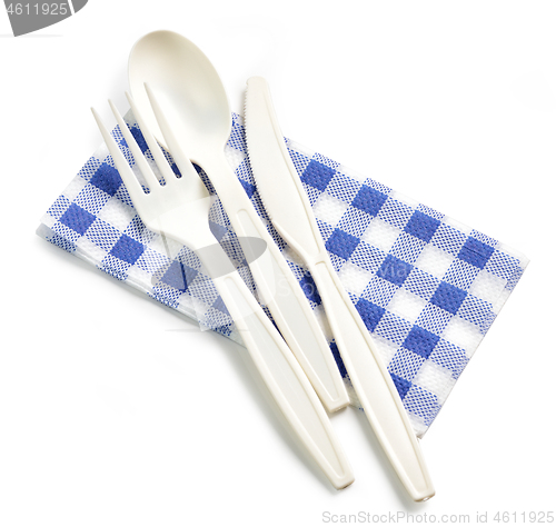 Image of white take away spoon and fork on paper napkin