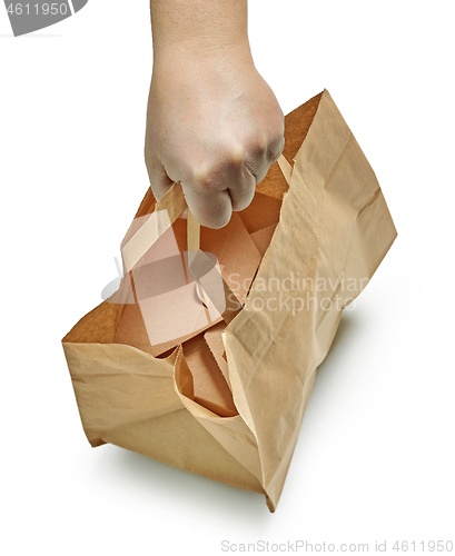 Image of paper bag in human hand