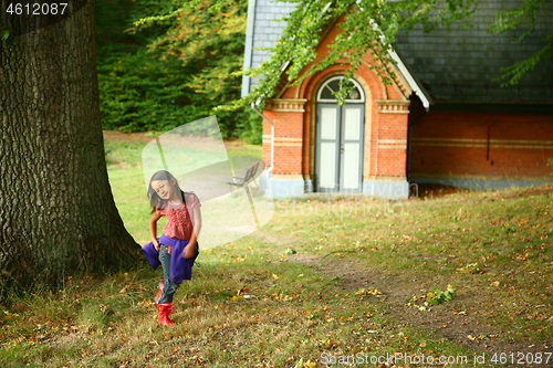 Image of Portrait of a young cute girl looking at the camera outdoor