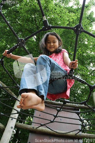 Image of Portrait of a young cute girl on a playing field