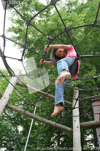 Image of Portrait of a young cute girl on a playing field