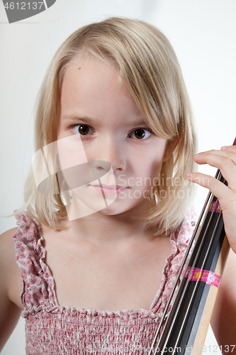 Image of Portrait of a young teenager girl in studio with a cello