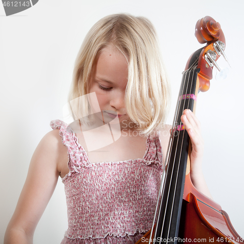 Image of Portrait of a young teenager girl in studio with a cello