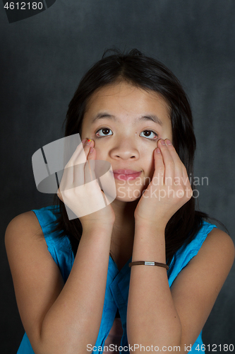 Image of Portrait of a young cute girl looking at the camera