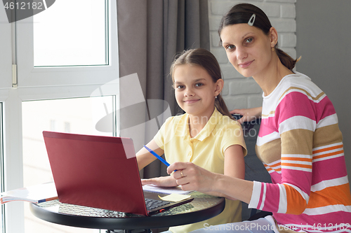 Image of Girl and mother undergo interactive online education at home