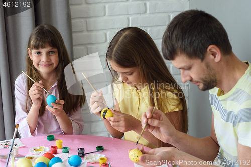 Image of Family paints easter eggs on easter holiday