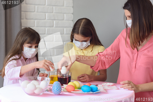 Image of Mom and two quarantined daughters prepare for Easter