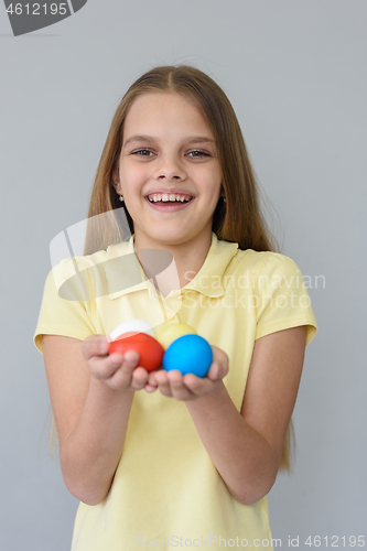 Image of Portrait of a girl with Easter eggs on a gray background