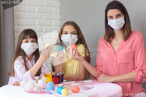 Image of quarantined family paints eggs for easter