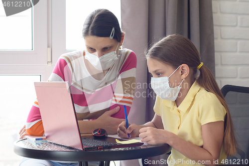 Image of The family understands how to learn in self-isolation mode online using a laptop