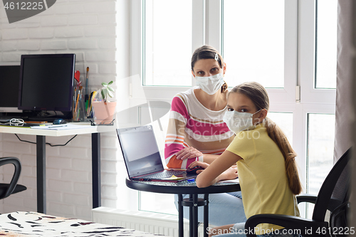 Image of Mom and quarantined daughter study in self-isolation mode without leaving home