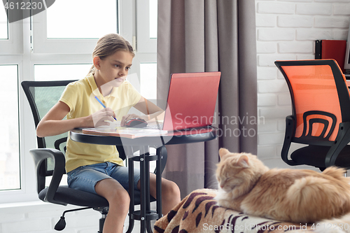 Image of Girl watching a school lesson online, in quarantine at home