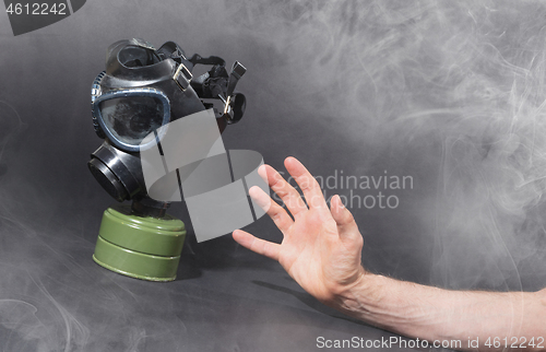 Image of Man in room filled with smoke, trying to reach for vintage gasma