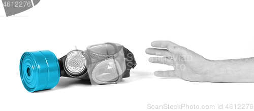 Image of Arm reaching for vintage gasmask isolated on white - Blue filter