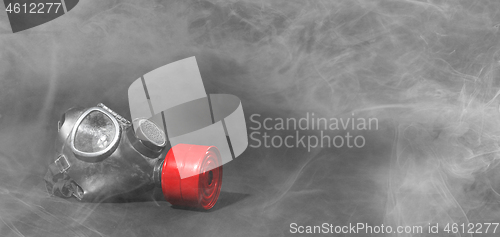 Image of Vintage gasmask isolated on black - Smoke in the room - Red filt