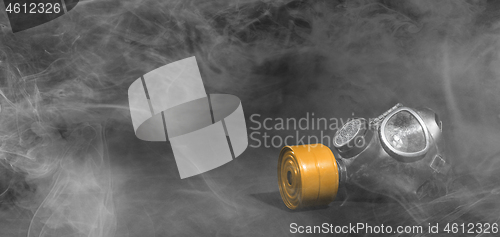 Image of Vintage gasmask isolated on black - Smoke in the room - Orange f