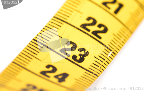 Image of Close-up of a yellow measuring tape isolated on white - 23