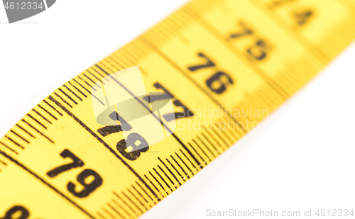 Image of Close-up of a yellow measuring tape isolated on white - 78