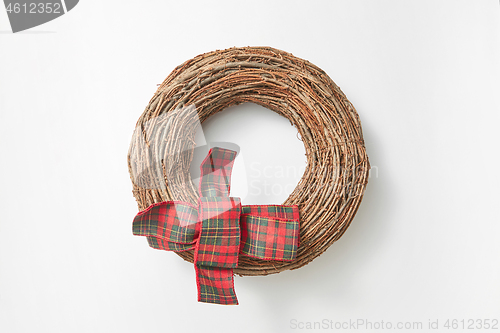 Image of Handcraft round wreath from twigs on a white background.