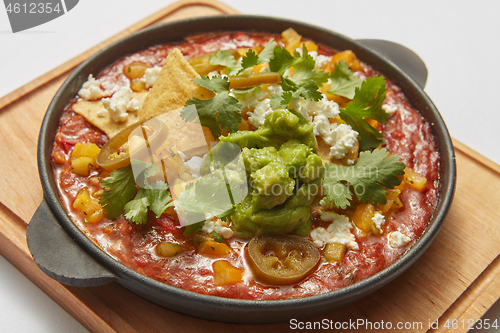 Image of Close-up view pan with Shakshuka dish with spicy sauce from tomatoes.