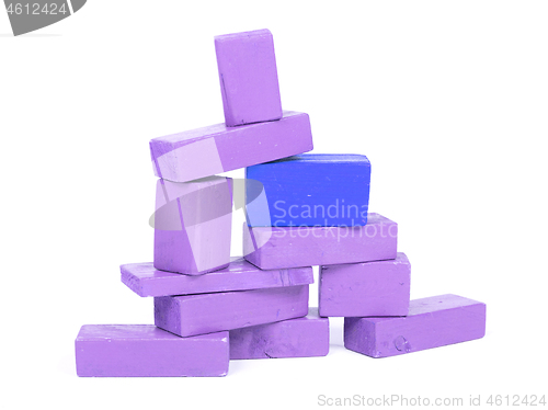 Image of Vintage purple building blocks isolated on white, one standing o