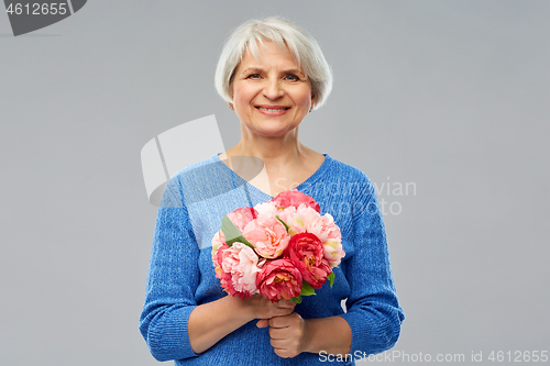 Image of happy smiling senior woman with flowers