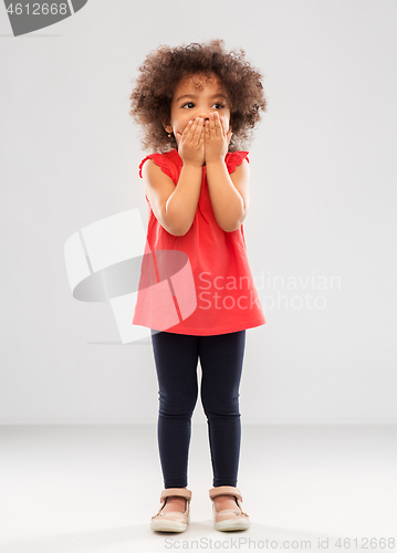 Image of confused african american girl covering mouth