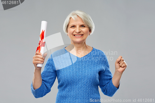 Image of happy senior graduate student woman with diploma