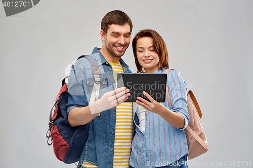 Image of happy couple of tourists with tablet computer