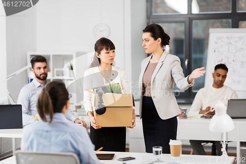 Image of fired sad female office worker leaving