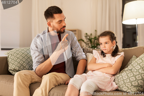 Image of upset or feeling guilty girl and father at home