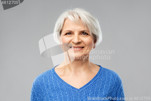 Image of portrait of smiling senior woman in blue sweater