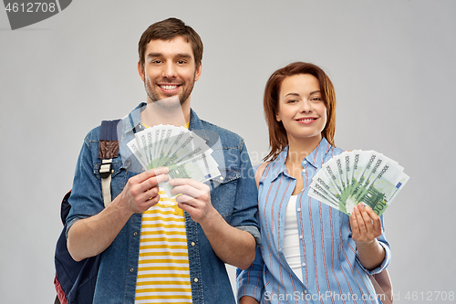 Image of couple of tourists with backpacks and money