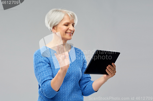 Image of senior woman having video call on tablet computer