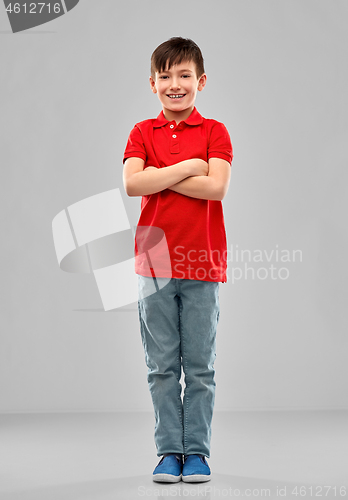 Image of smiling boy in red polo t-shirt with crossed arms