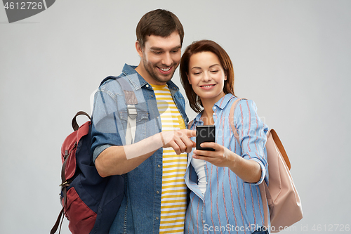 Image of happy couple of tourists with smartphone