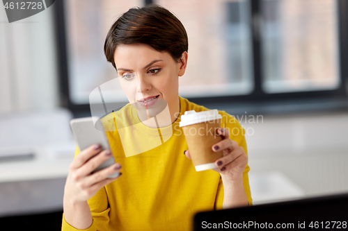 Image of businesswoman calling on smartphone at office