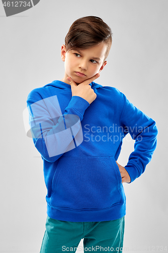 Image of thinking boy in blue hoodie