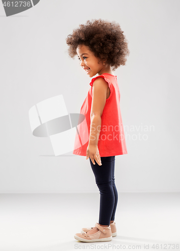 Image of happy little african american girl over grey