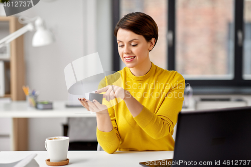 Image of businesswoman using smart speaker at office