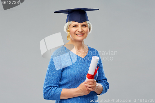 Image of happy senior graduate student woman with diploma