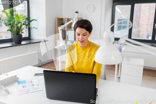 Image of creative woman working on user interface at office